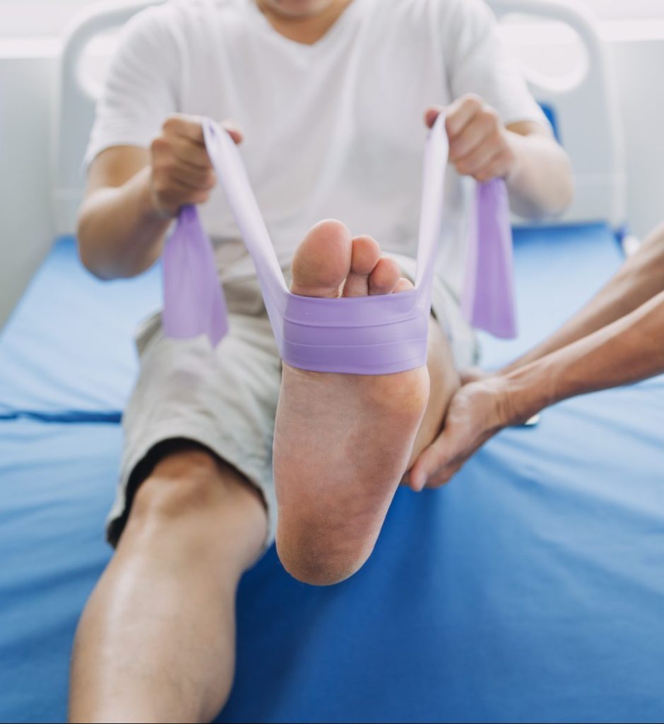 patient using resistance bands at physical therapy