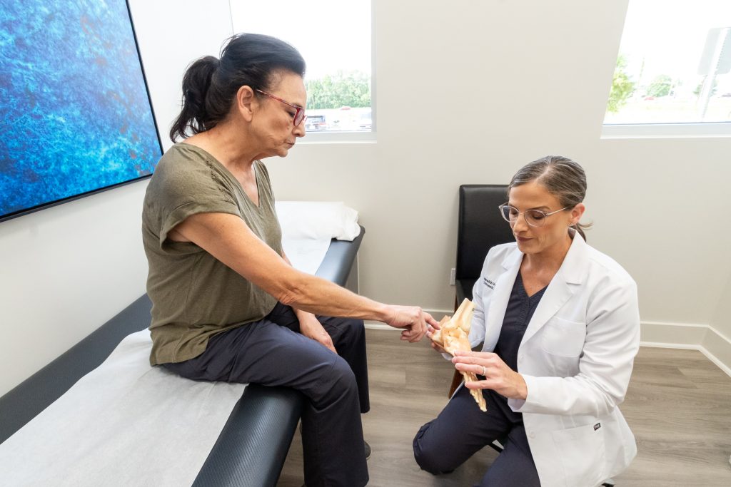 dr warner teaching patient about foot pain
