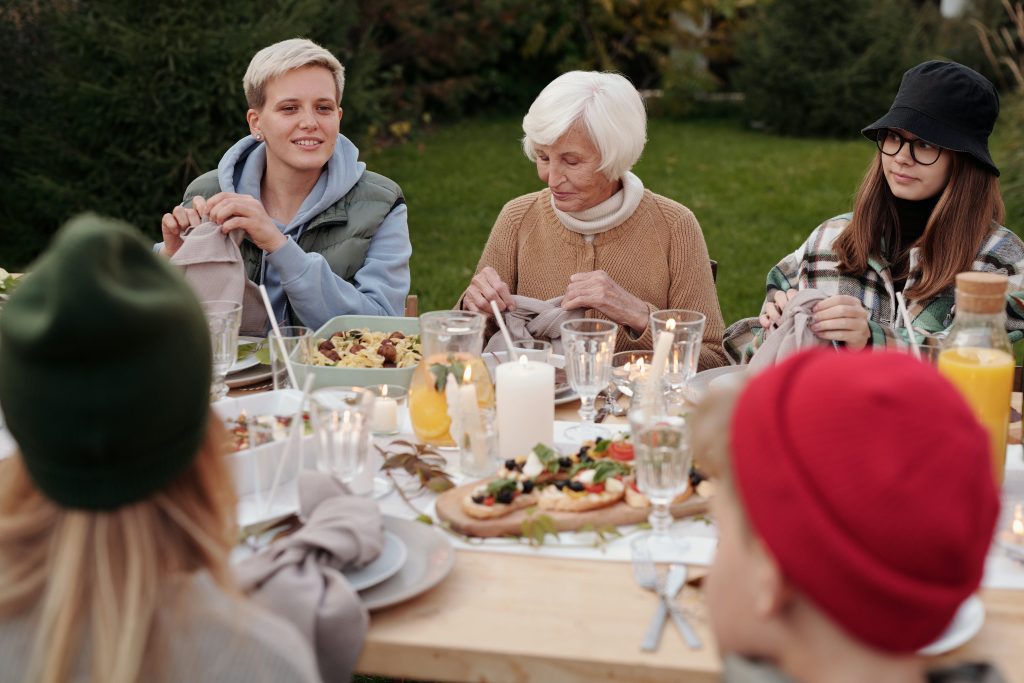 happy older woman eating with family