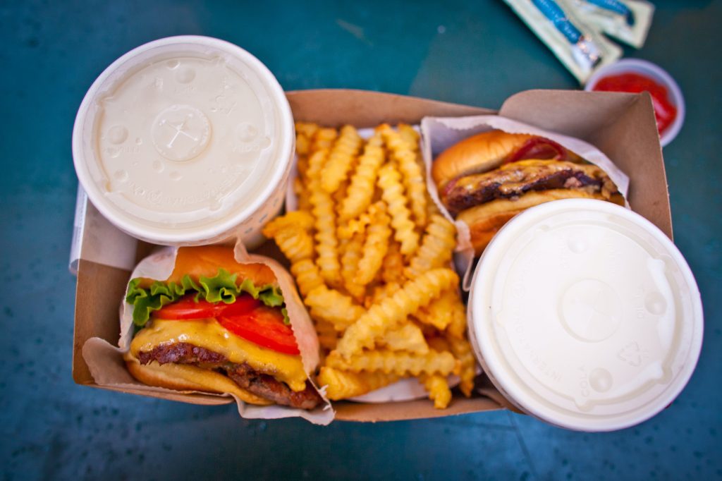tray with burgers fries and shakes